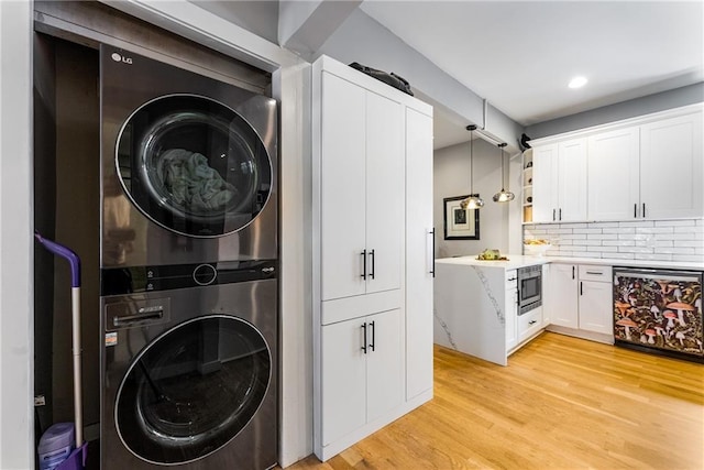 611 Pickett St SE, Atlanta, GA 30316 - laundry area with stacked washer / dryer, light wood finished floors, and recessed lighting