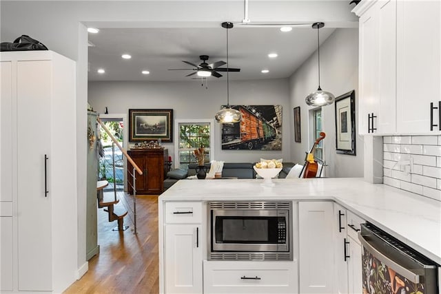 611 Pickett St SE, Atlanta, GA 30316 - kitchen with appliances with stainless steel finishes, a peninsula, recessed lighting, ceiling fan, and light stone countertops