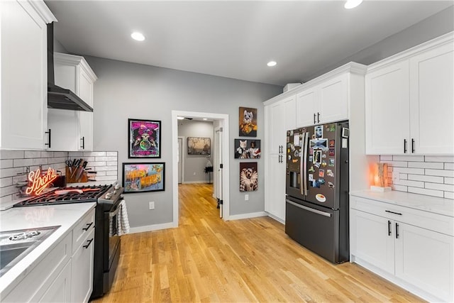 611 Pickett St SE, Atlanta, GA 30316 - kitchen with stainless steel fridge, light countertops, range with gas cooktop, white cabinetry, and recessed lighting