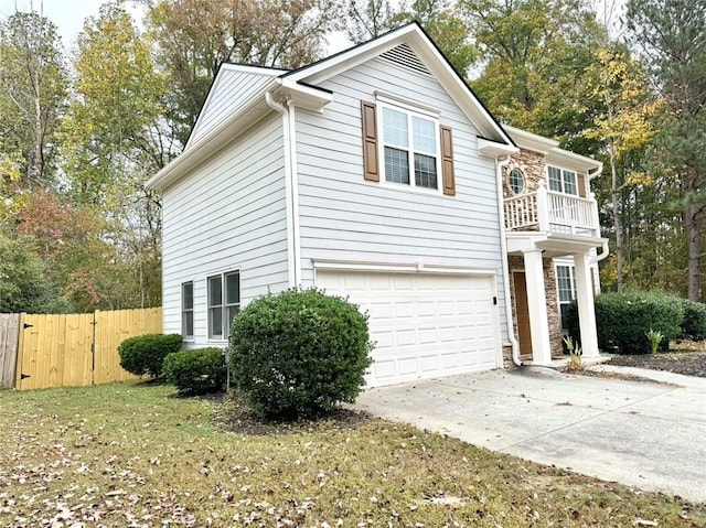 view of property exterior with a lawn, a balcony, and a garage