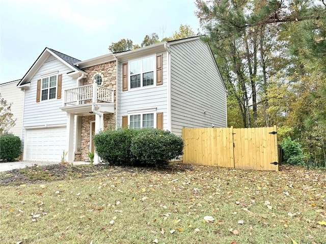 view of front of house featuring a balcony, a front yard, and a garage