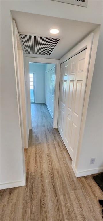 hallway with light wood-type flooring