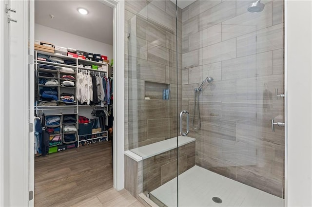 bathroom featuring an enclosed shower and hardwood / wood-style flooring