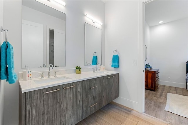 bathroom with hardwood / wood-style flooring and vanity