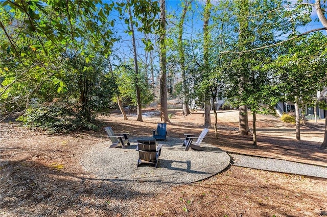 surrounding community featuring an outdoor fire pit