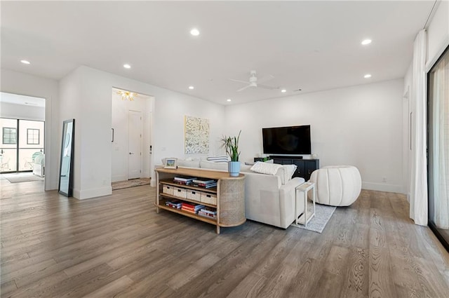 living room with hardwood / wood-style floors and ceiling fan