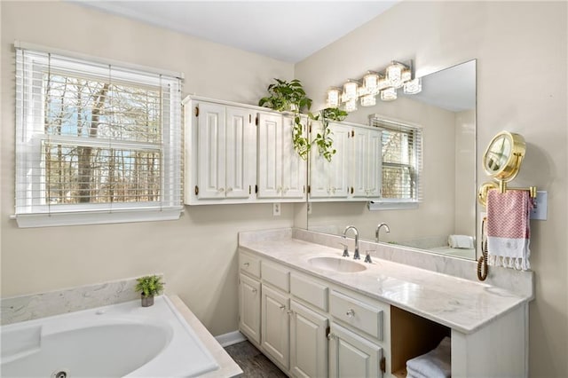 bathroom with vanity and a bath