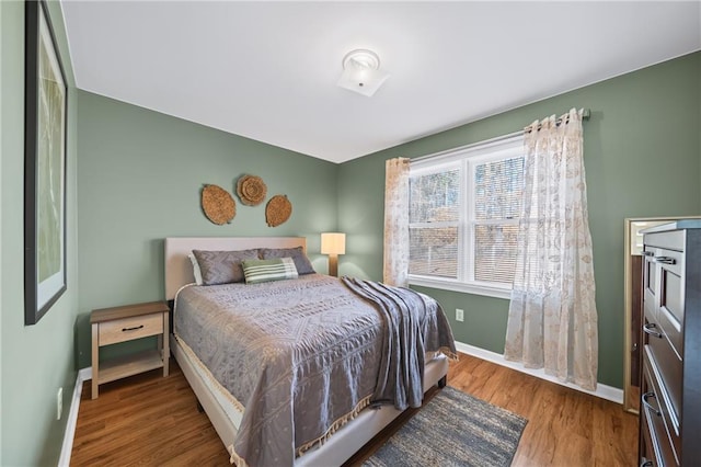 bedroom with hardwood / wood-style flooring