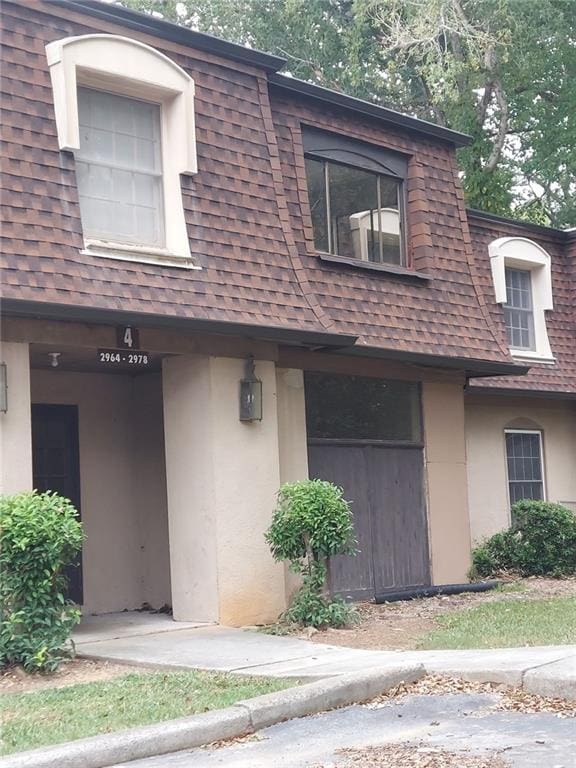 2968 Parc Lorraine, Lithonia, GA 30038 - view of front facade with a shingled roof, stucco siding, and mansard roof