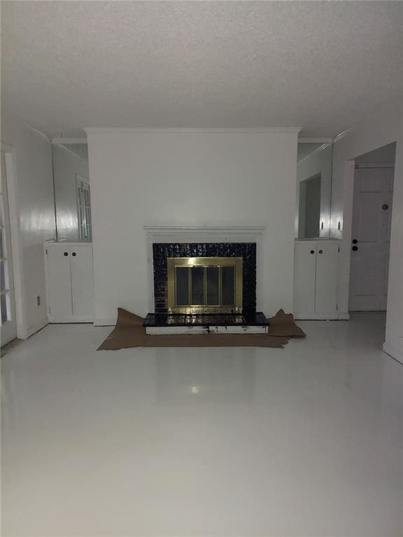 unfurnished living room featuring ornamental molding, a premium fireplace, and a textured ceiling