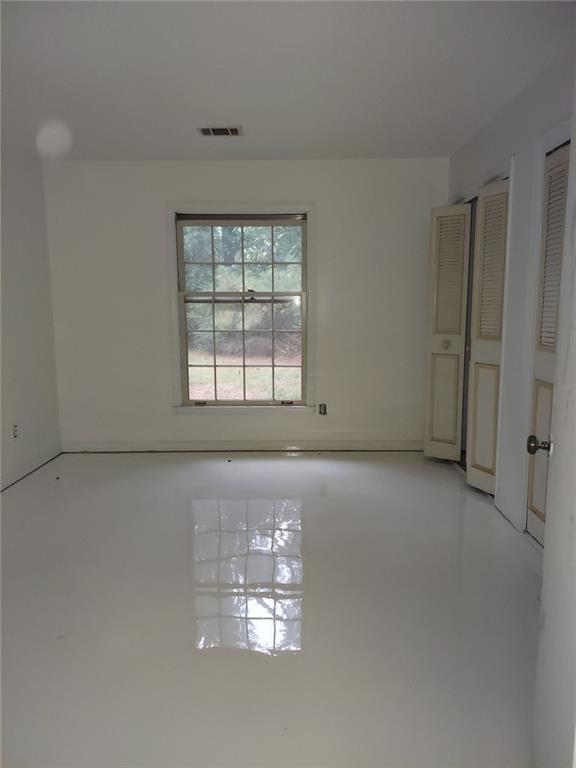 2968 Parc Lorraine, Lithonia, GA 30038 - spare room featuring finished concrete flooring