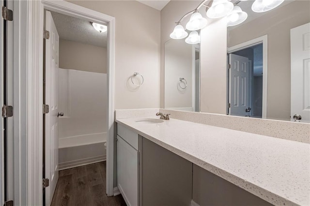 bathroom featuring a textured ceiling, independent shower and bath, vanity, and hardwood / wood-style floors