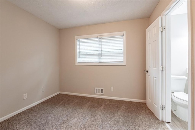 unfurnished bedroom featuring carpet and a textured ceiling