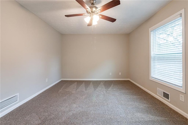 carpeted spare room featuring ceiling fan