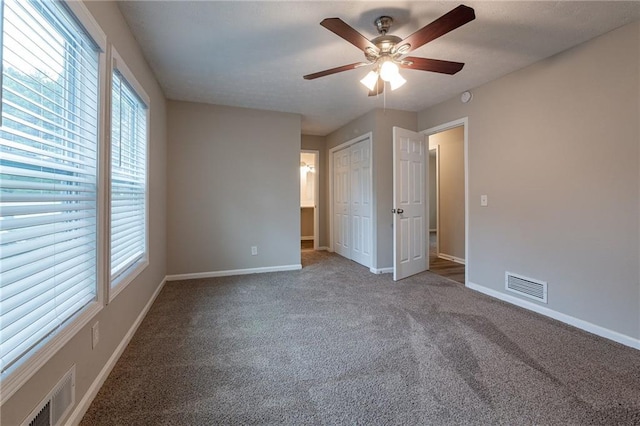 unfurnished bedroom featuring a closet, ceiling fan, and carpet flooring