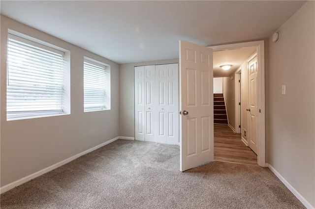 unfurnished bedroom with a closet and carpet flooring