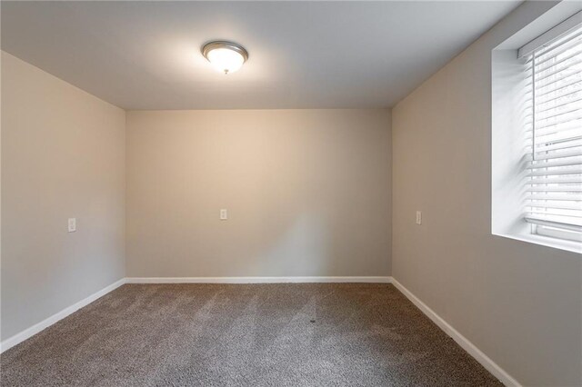 carpeted spare room featuring a healthy amount of sunlight