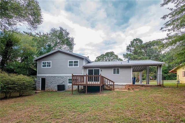 back of property featuring a wooden deck, central AC, and a yard