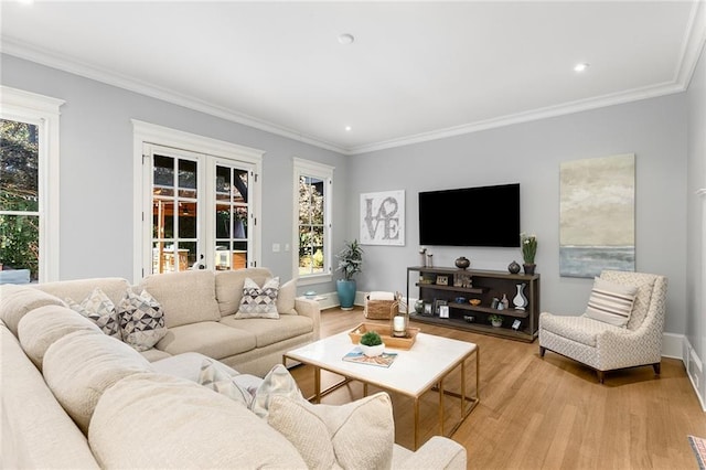 living room with light wood-type flooring, crown molding, and french doors