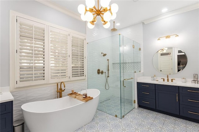 bathroom with vanity, crown molding, tile walls, plus walk in shower, and a chandelier