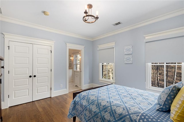 bedroom featuring crown molding, a closet, and dark wood-type flooring