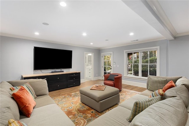 living room featuring light hardwood / wood-style floors and crown molding