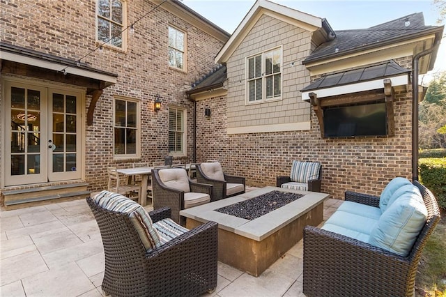 view of patio / terrace featuring french doors and an outdoor fire pit