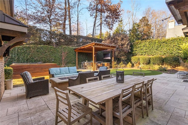 view of patio with exterior bar and an outdoor fire pit