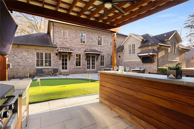 view of patio / terrace featuring ceiling fan and a bar