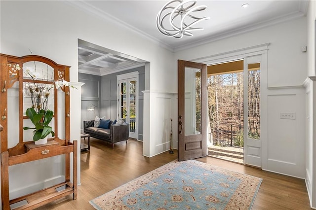 entryway featuring crown molding, beamed ceiling, wood-type flooring, and coffered ceiling