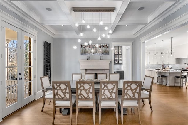 dining room with beamed ceiling, dark hardwood / wood-style flooring, crown molding, and french doors