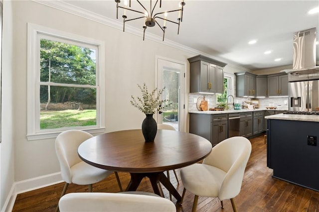 kitchen with island exhaust hood, appliances with stainless steel finishes, dark hardwood / wood-style flooring, tasteful backsplash, and gray cabinets