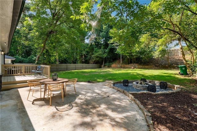 view of patio with a fire pit and a wooden deck