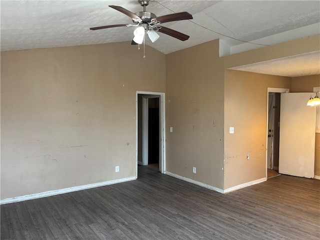 empty room with ceiling fan, dark wood-type flooring, a textured ceiling, and lofted ceiling