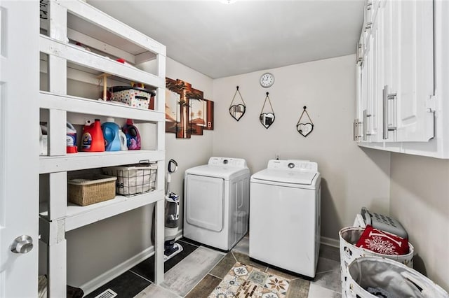laundry area featuring cabinet space, washing machine and clothes dryer, and baseboards