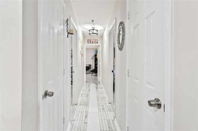 corridor with light tile patterned floors