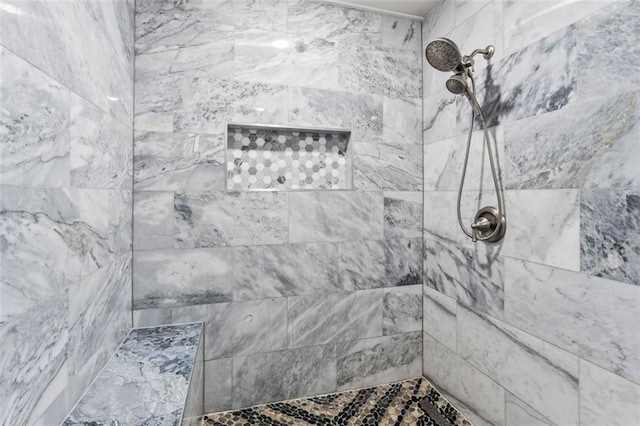 full bath featuring tiled shower