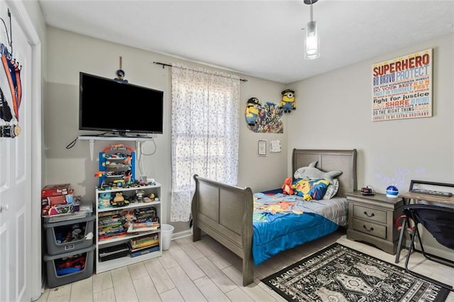 bedroom with baseboards and wood finished floors