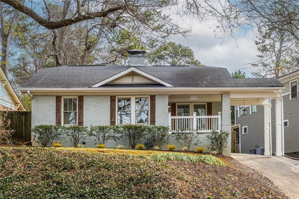 ranch-style home with central AC unit and a porch