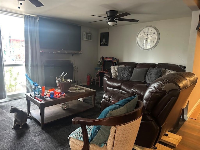 living room featuring a wall mounted air conditioner and ceiling fan