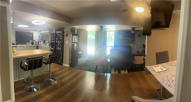 kitchen featuring ceiling fan and dark wood finished floors