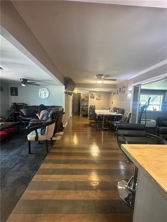 living area featuring a ceiling fan and wood finished floors