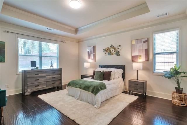 30 Lismore Way, Newnan, GA 30263 - bedroom featuring a tray ceiling, crown molding, dark wood-type flooring, and baseboards