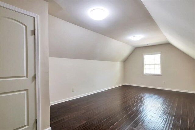 30 Lismore Way, Newnan, GA 30263 - bonus room with dark wood-style floors, lofted ceiling, and baseboards