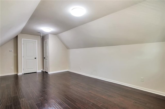 30 Lismore Way, Newnan, GA 30263 - additional living space with dark wood finished floors, vaulted ceiling, and baseboards