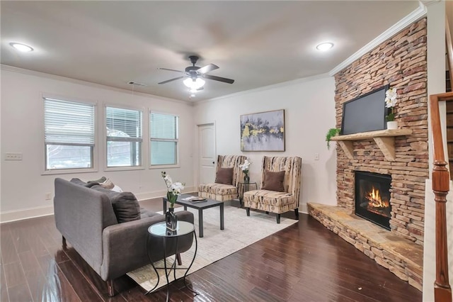 30 Lismore Way, Newnan, GA 30263 - living area with crown molding, a stone fireplace, baseboards, a ceiling fan, and dark wood-style floors