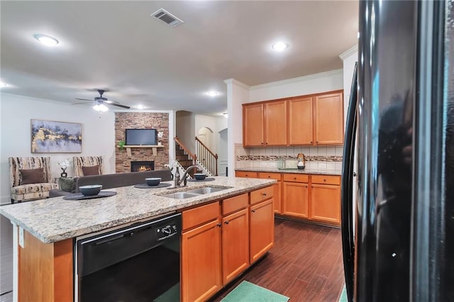 30 Lismore Way, Newnan, GA 30263 - kitchen with black appliances, a sink, a ceiling fan, dark wood finished floors, and a fireplace