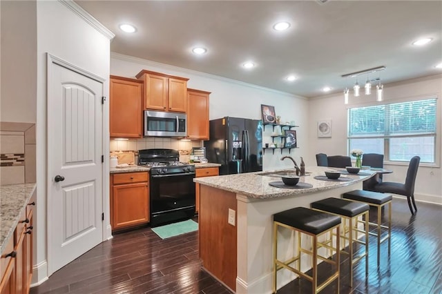 30 Lismore Way, Newnan, GA 30263 - kitchen featuring black appliances, a sink, ornamental molding, tasteful backsplash, and a breakfast bar area