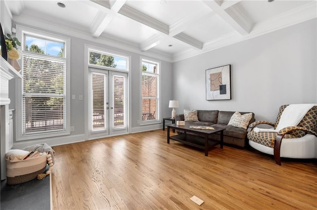 living room with light wood-style floors, beamed ceiling, coffered ceiling, french doors, and crown molding