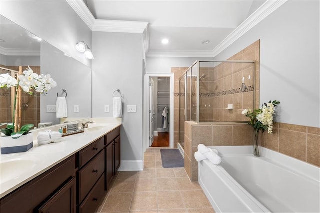 bathroom featuring a shower stall, ornamental molding, a garden tub, tile patterned floors, and double vanity